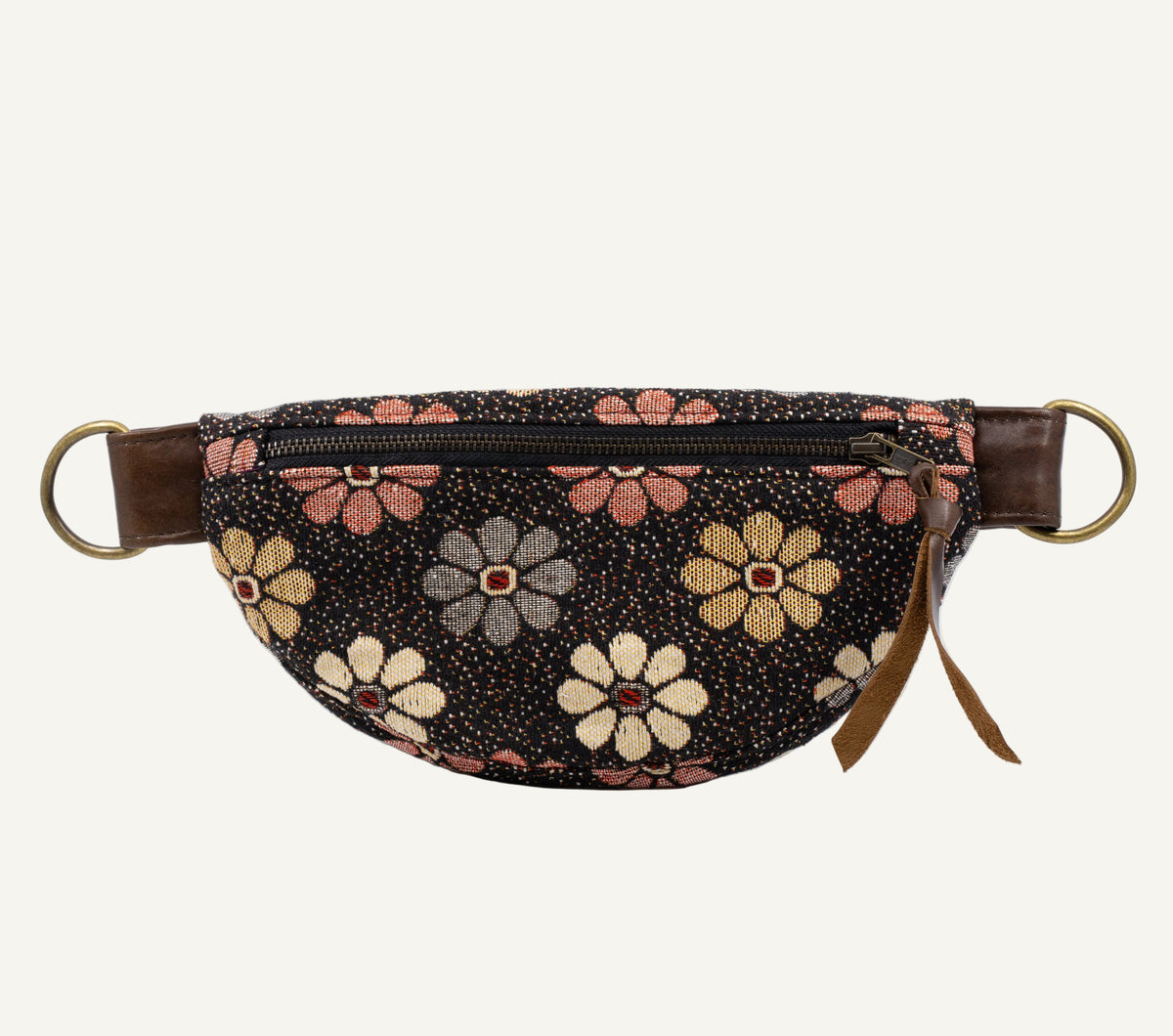 A black waist bag featuring a colorful floral pattern with pink, yellow, and gray flowers, brown leather side straps, and brass-tone metal rings, shown against a plain white background.