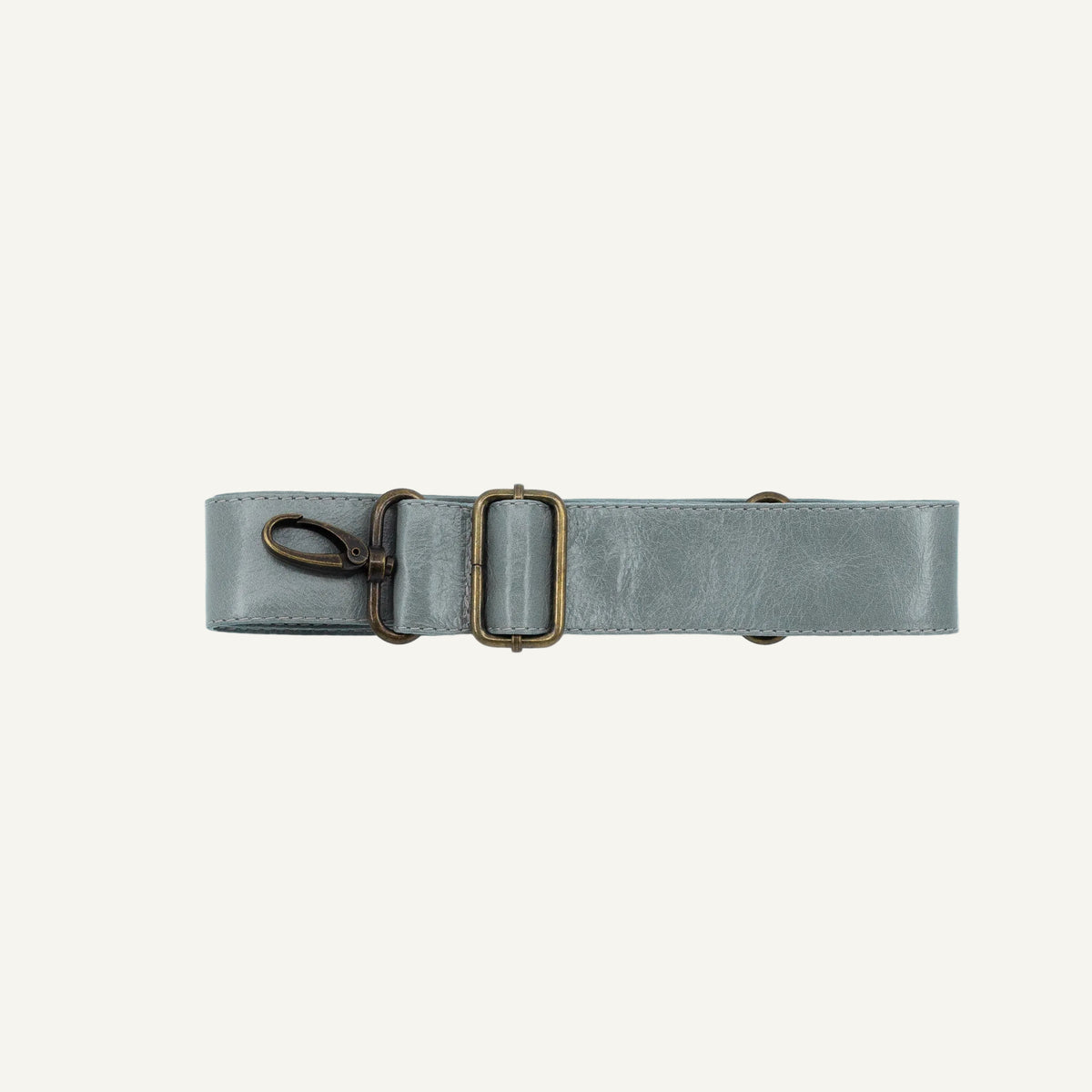 A light gray leather belt with an antique bronze buckle and a matching metal swivel clasp, displayed horizontally on a clean white background.