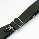 An olive green textured leather strap with silver-tone metal hardware, including a buckle, adjustment loop, and lobster clasp, shown on a clean white background.