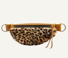 A leopard-print faux fur waist bag with tan leather trim and gold-tone hardware, shown against a plain white background.