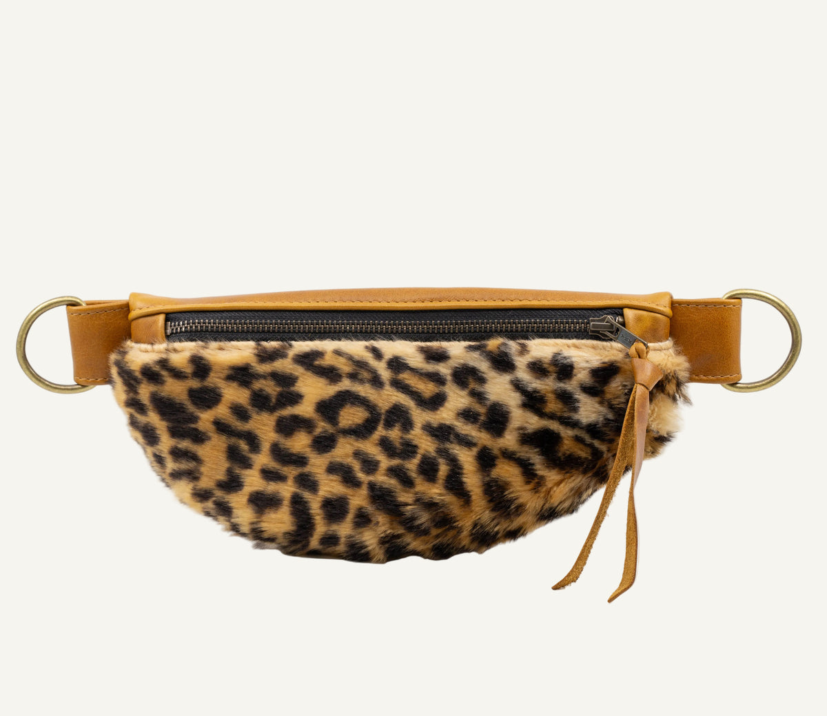 A leopard-print faux fur waist bag with tan leather trim and gold-tone hardware, shown against a plain white background.